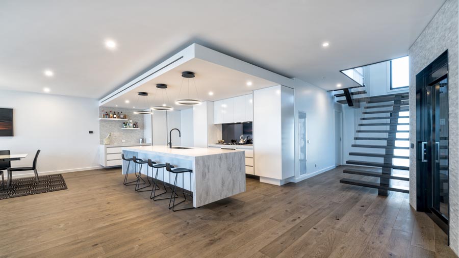 Modern open-plan kitchen with island and staircase