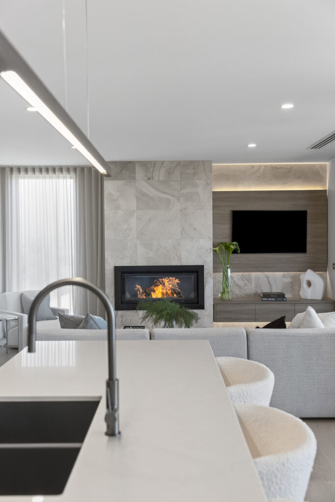 Modern living room with marble fireplace and TV