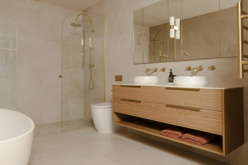 Modern bathroom with timber vanity and brass fixtures