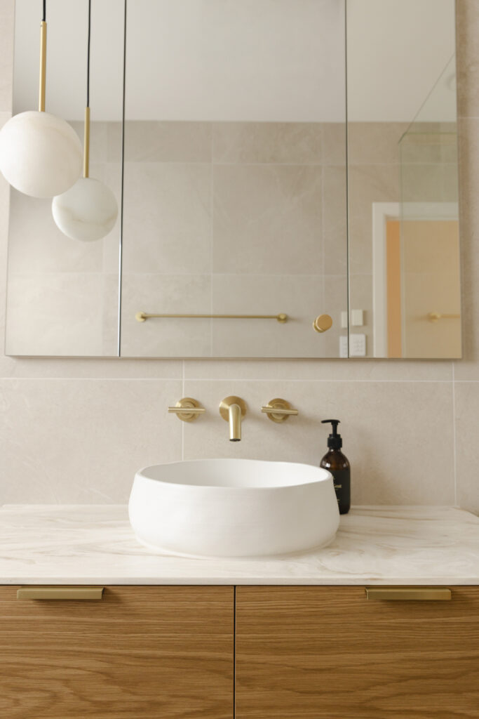 Modern bathroom vanity with brass tapware and vessel sink